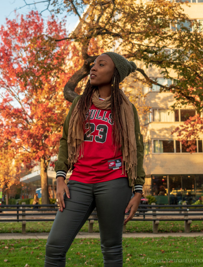 A portrait of a woman wearing a Chicago Bulls jersey in DuPont Circle in autumn