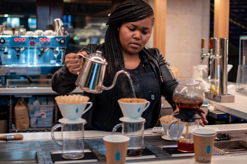 A spontaneous shot of a woman pouring coffee