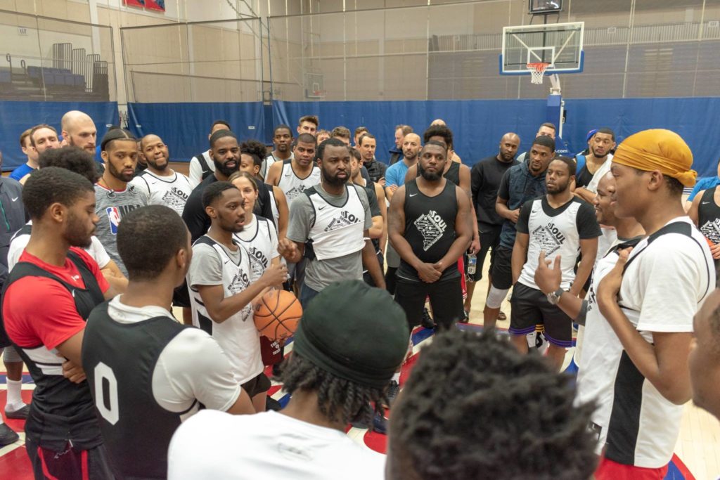 Participants at a basketball tournament gather to hear a speech