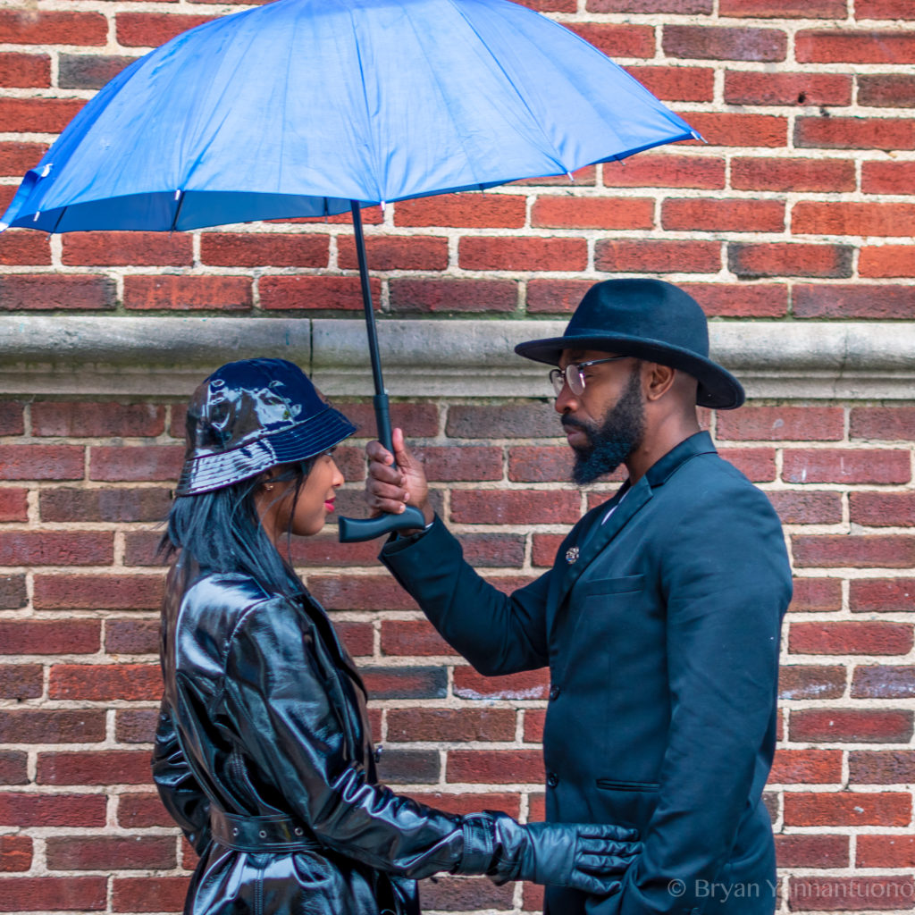 Picture of a man holding an umbrella for a woman