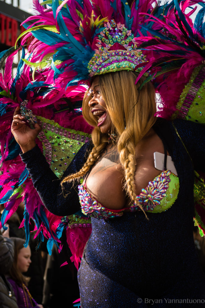 An excited woman walks in a Mardi Gras parade