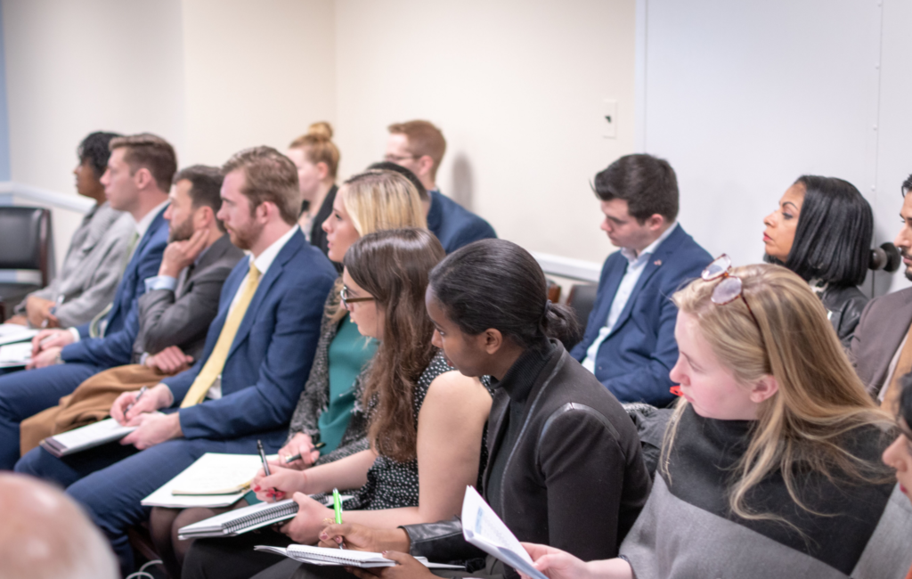 Photograph of a crowd intently listening to a presentation