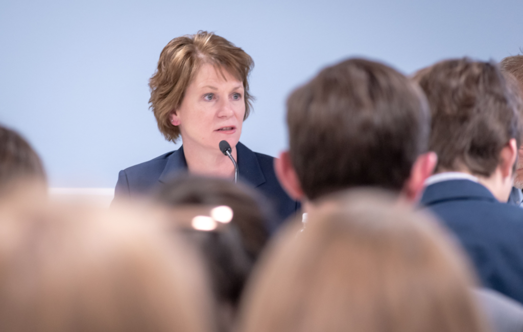 A professional woman speaks at an event