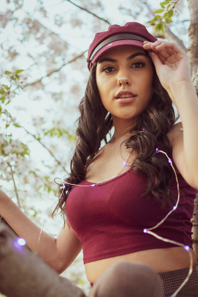 Picture of a beautiful brunette model posing in a cherry blossom tree in Washington, DC