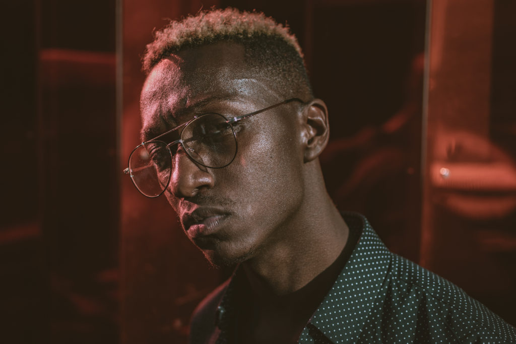 Portrait photography of a black male model posing with a serious face