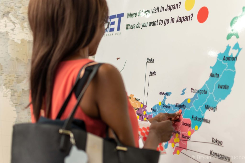 Event photography of a woman looking at a map of Japan