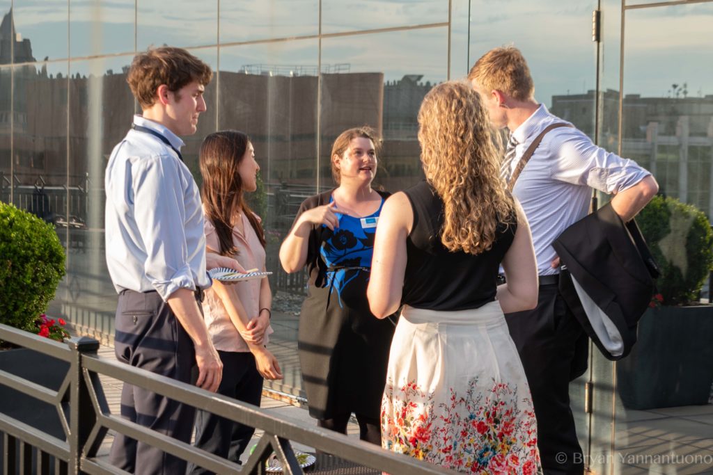 Photo of a group of people enjoying a rooftop happy hour