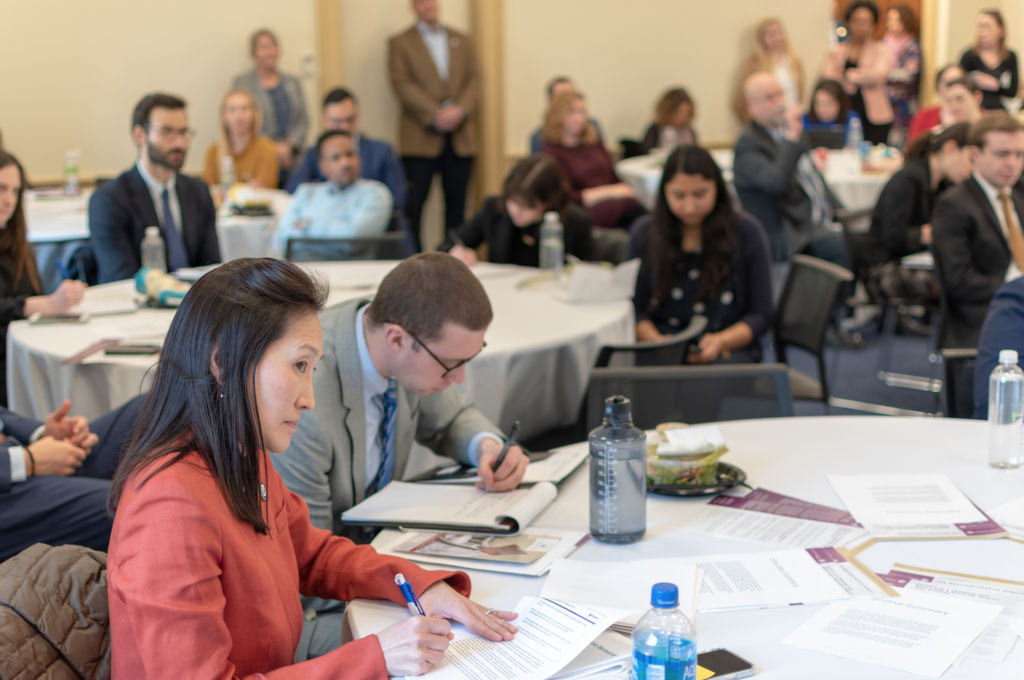 A crowd takes notes at a capitol hill briefing